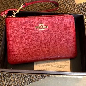 LIKE NEW Authentic Coach wristlet in red.